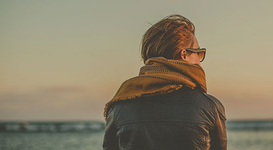Woman sitting at a wharf, thinking